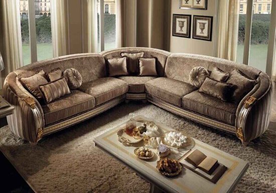 Γωνιακός καναπές σχεδιασμένος σε χρώμα γκρι με στρογγυλεμένα μπράτσα