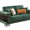 Διθέσιος καναπές ο οποίος είναι σχεδιασμένος σε χρώμα κυπαρισσί με μεταλλικές καφέ λεπτομέρειες.